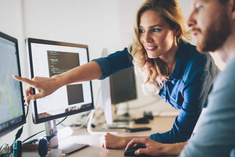 Woman showing a man a design on a computer